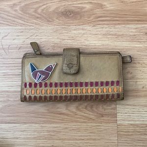 Fossil leather wallet with bird and pink/orange details.